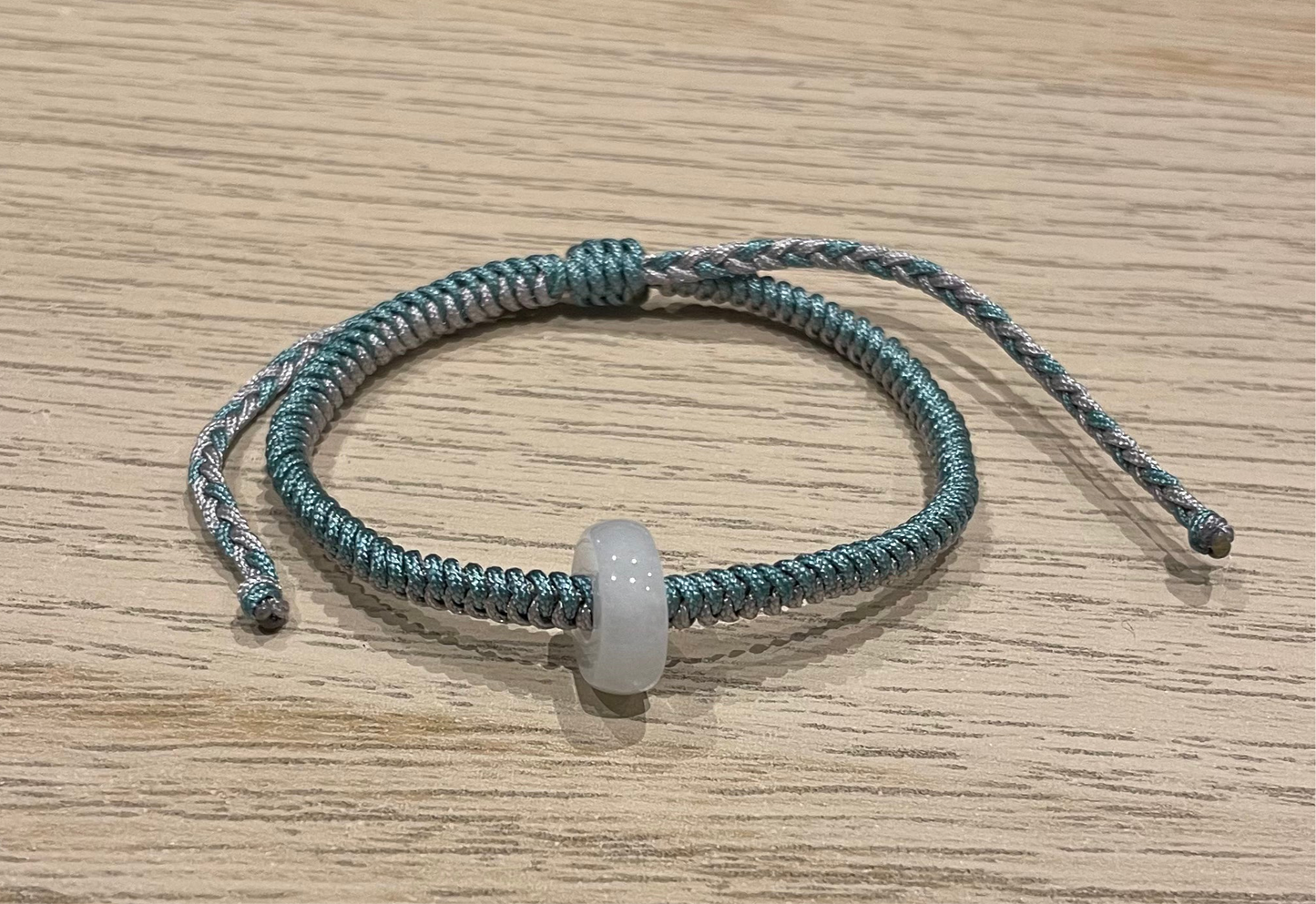 Handmade bracelet with a white jade charm