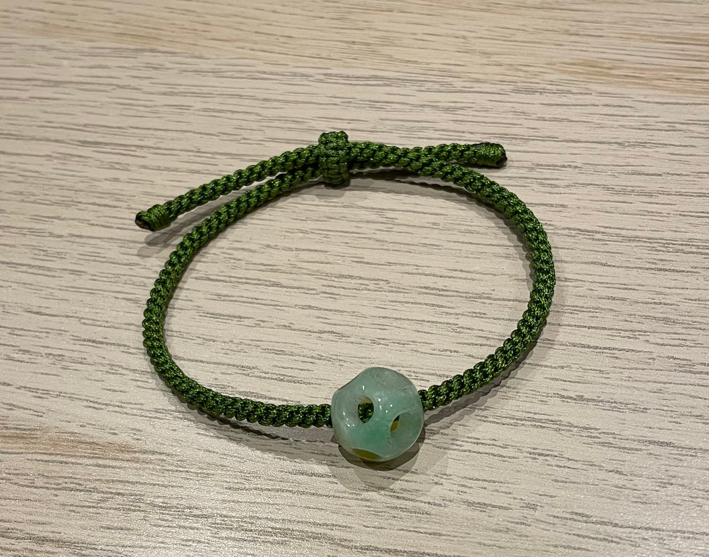 Handmade bracelet with a green jade charm