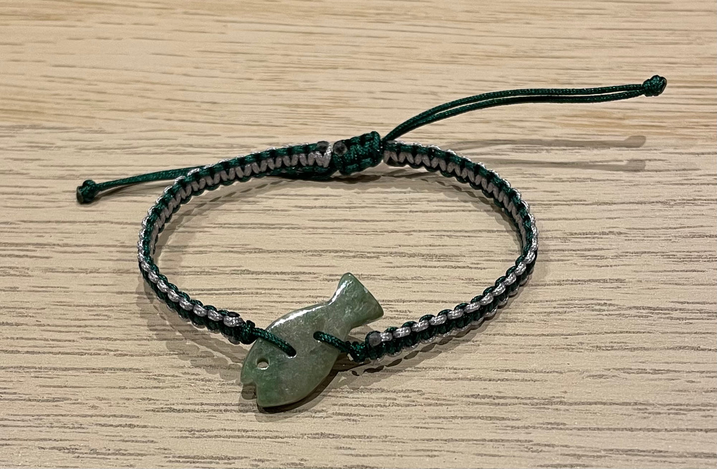 Handmade bracelet with a green jade fish charm