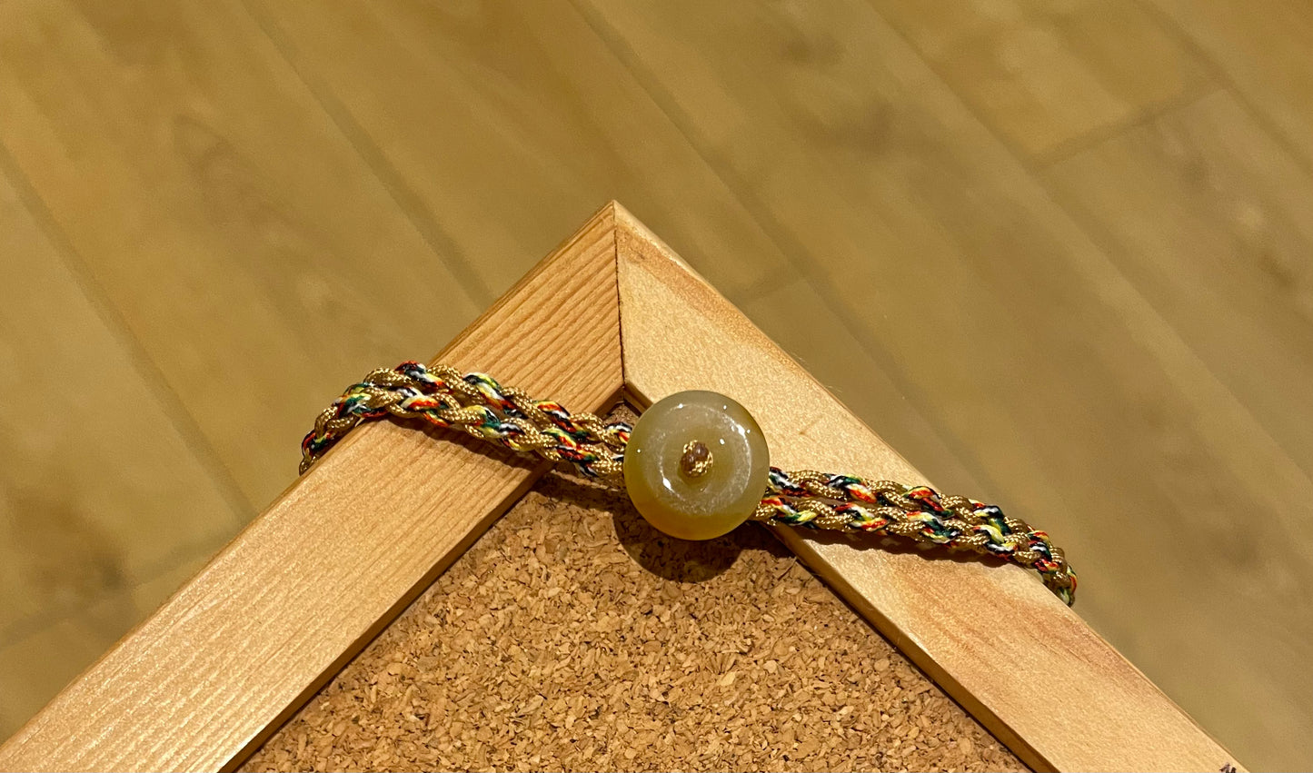 Handmade bracelet with a tiny yellow jade donut