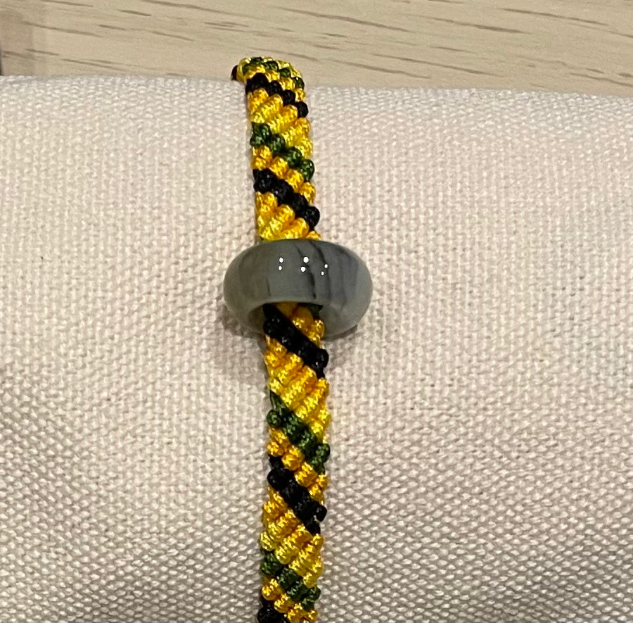 Handmade colourful bracelet with a jade ring