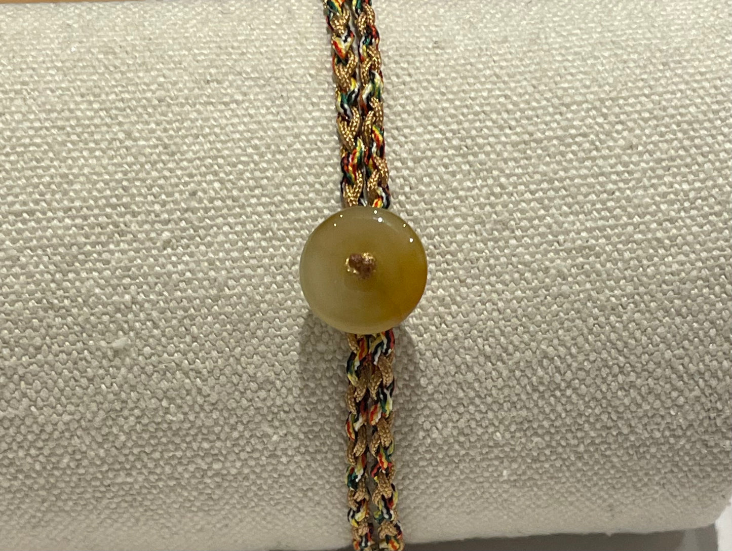 Handmade bracelet with a tiny yellow jade donut