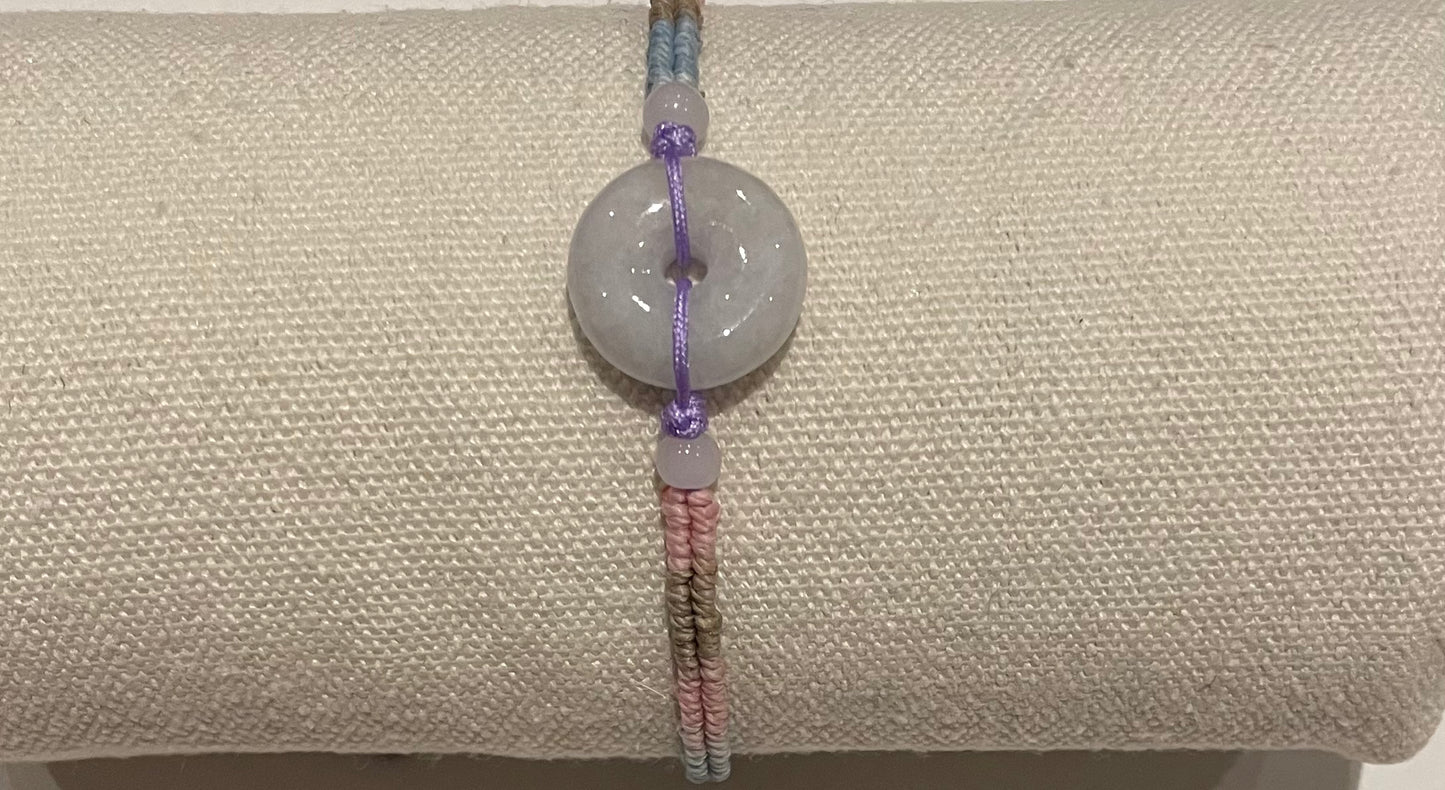 Handmade bracelet with light purple jade donut and gradient colour waxed string